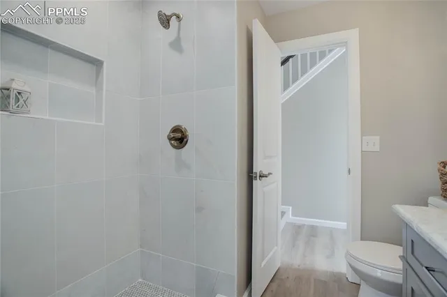 a bathroom with a granite countertop shower