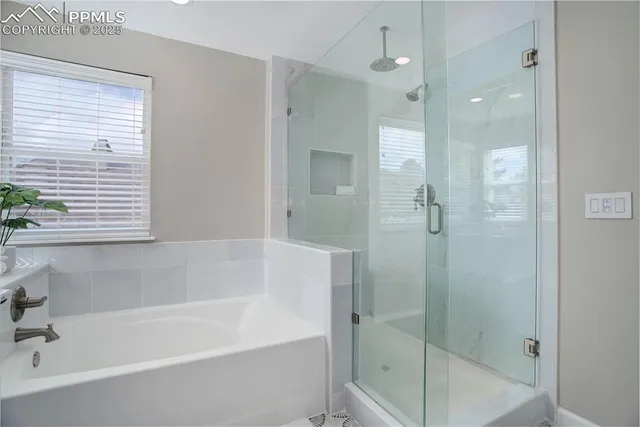 a white bath tub sitting next to a shower