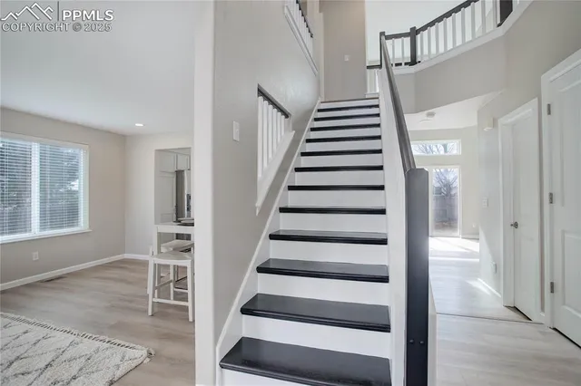 a view of staircase with white walls and windows