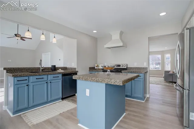 a kitchen with granite countertop a sink stove and cabinets