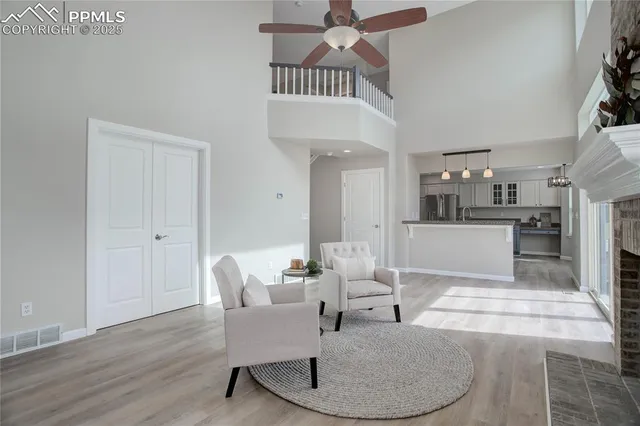a living room with furniture and a kitchen view