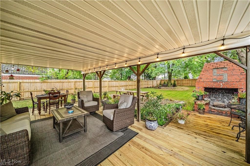 1317 Belrose Road Cleveland, OH 44124 - Photo 30 of 50 Wooden deck with outdoor dining space, an outdoor living space with a fireplace, and a fenced backyard