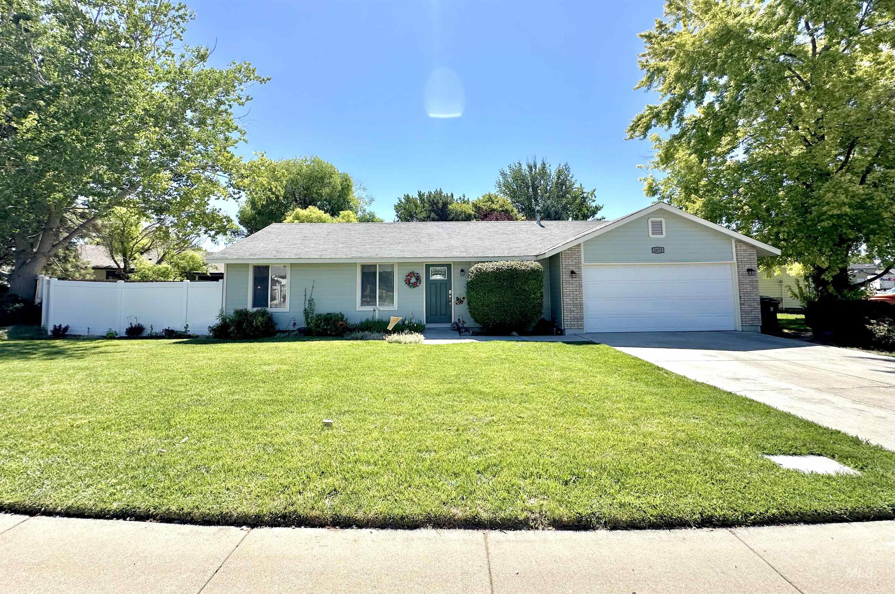 2472 North Maxie Way Meridian, ID 83646 - Photo 1 of 23 Ranch-style residence featuring a prominent front lawn, a two-car garage, and a light-toned exterior with brick accents