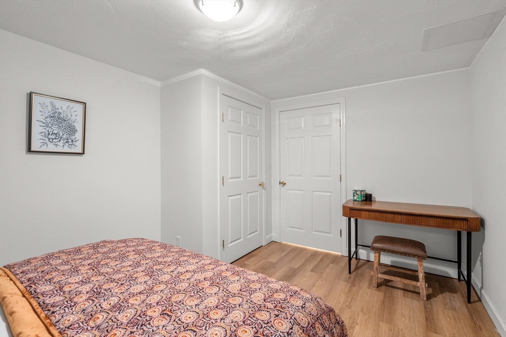 322 Concord Road Wayland, MA 01778 - Photo 29 of 35 a bedroom with a bed and a dresser
