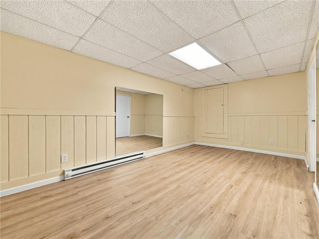 90 Gun Club Road Palmerton, PA 18071 - Photo 52 of 58 Warm wood flooring and classic wainscoting bring functional character to this versatile basement room.