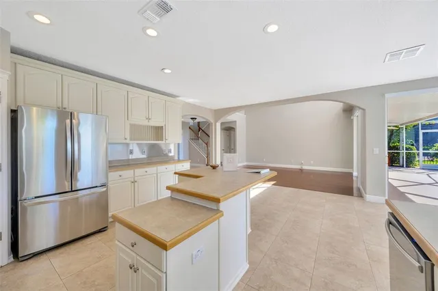 a kitchen with refrigerator and cabinets