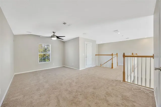 a view of a livingroom with a ceiling fan and window