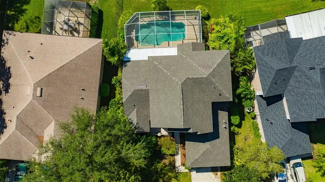 an aerial view of a house with a yard