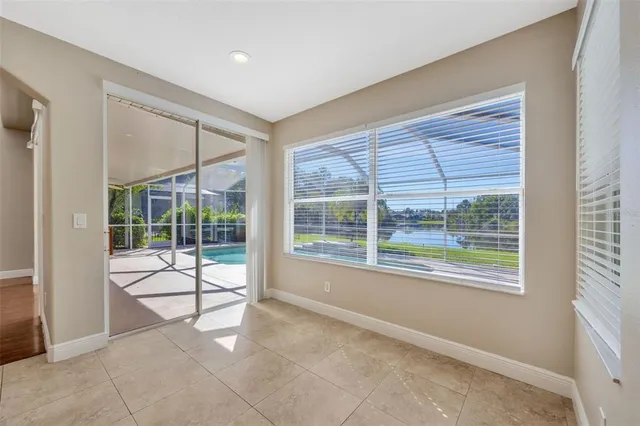 a view of a room with wooden floor and windows