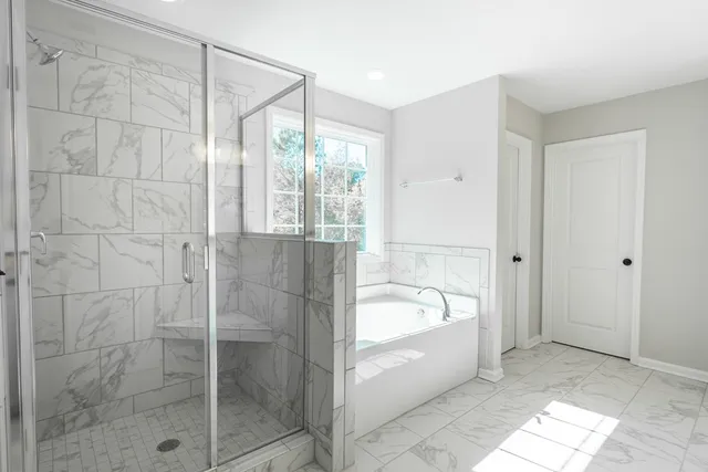 a spacious bathroom with a bathtub and a shower