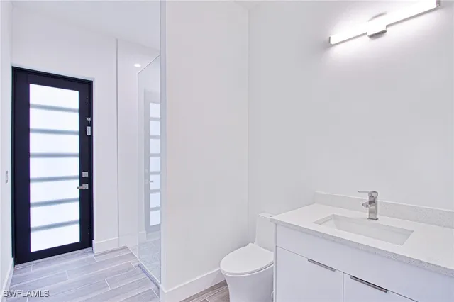 a bathroom with a sink a toilet and vanity