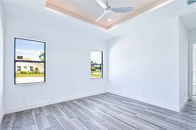 wooden floor in an empty room with a window