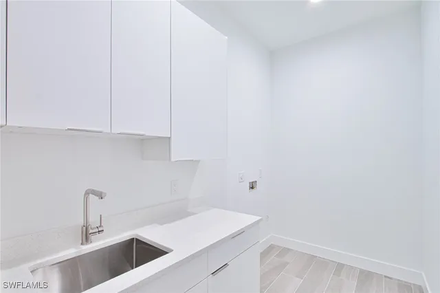 a view of a kitchen with white cabinets