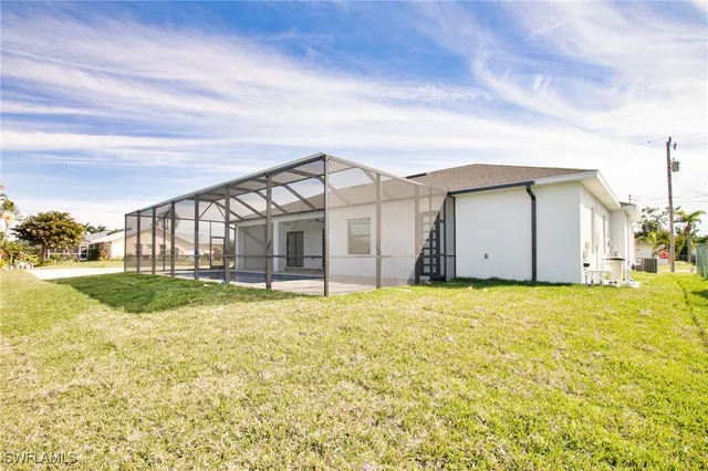 a view of a house with backyard and sitting area