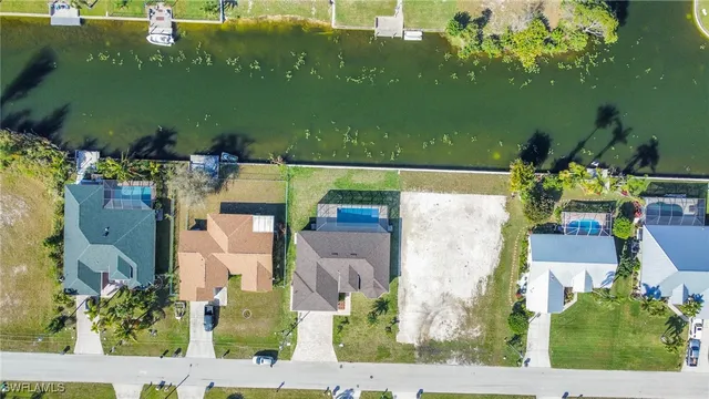 an aerial view of residential houses with outdoor space and swimming pool