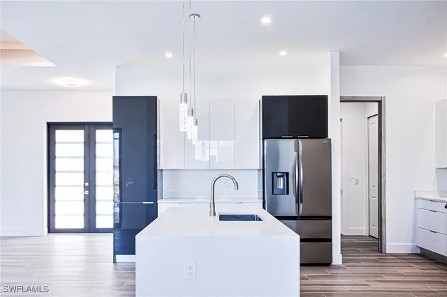a view of empty room with wooden floor and window