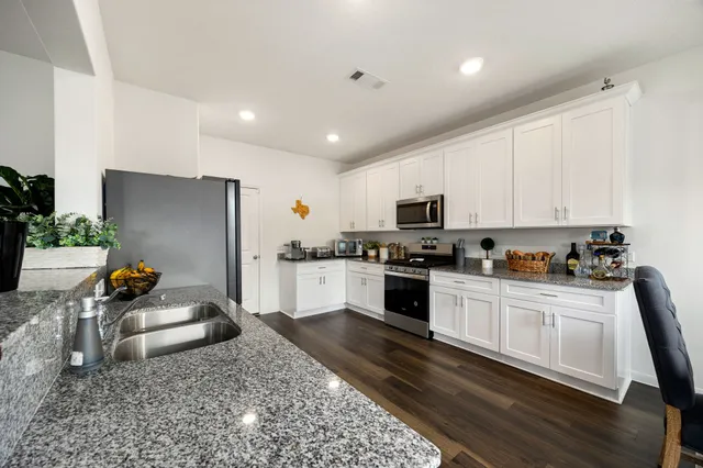 a kitchen with sink refrigerator and stove