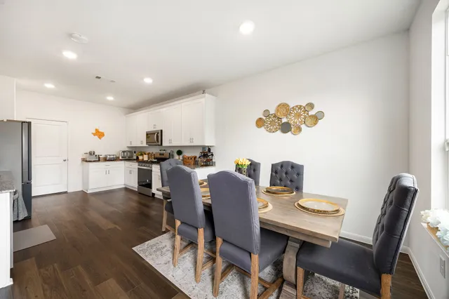 a view of a dining room with furniture and wooden floor
