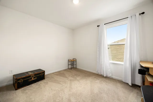 a room with a window and a chair