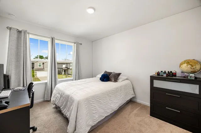 a bedroom with a bed and with furniture