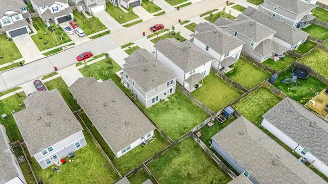 an aerial view of a house with a yard and greenery