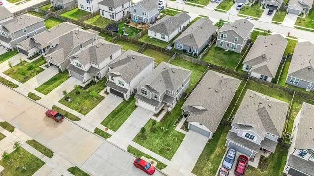 an aerial view of residential house with outdoor space and parking