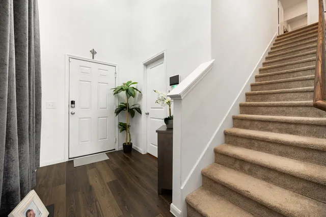 a view of entryway and hall with wooden floor