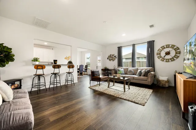 a living room with furniture and wooden floor