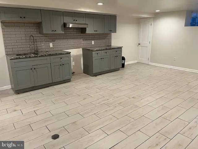 a kitchen with stainless steel appliances granite countertop a sink and cabinets