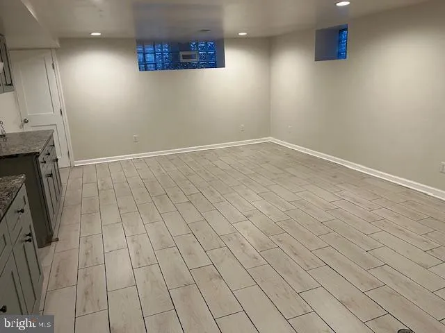 an empty room with a wooden floor and a window