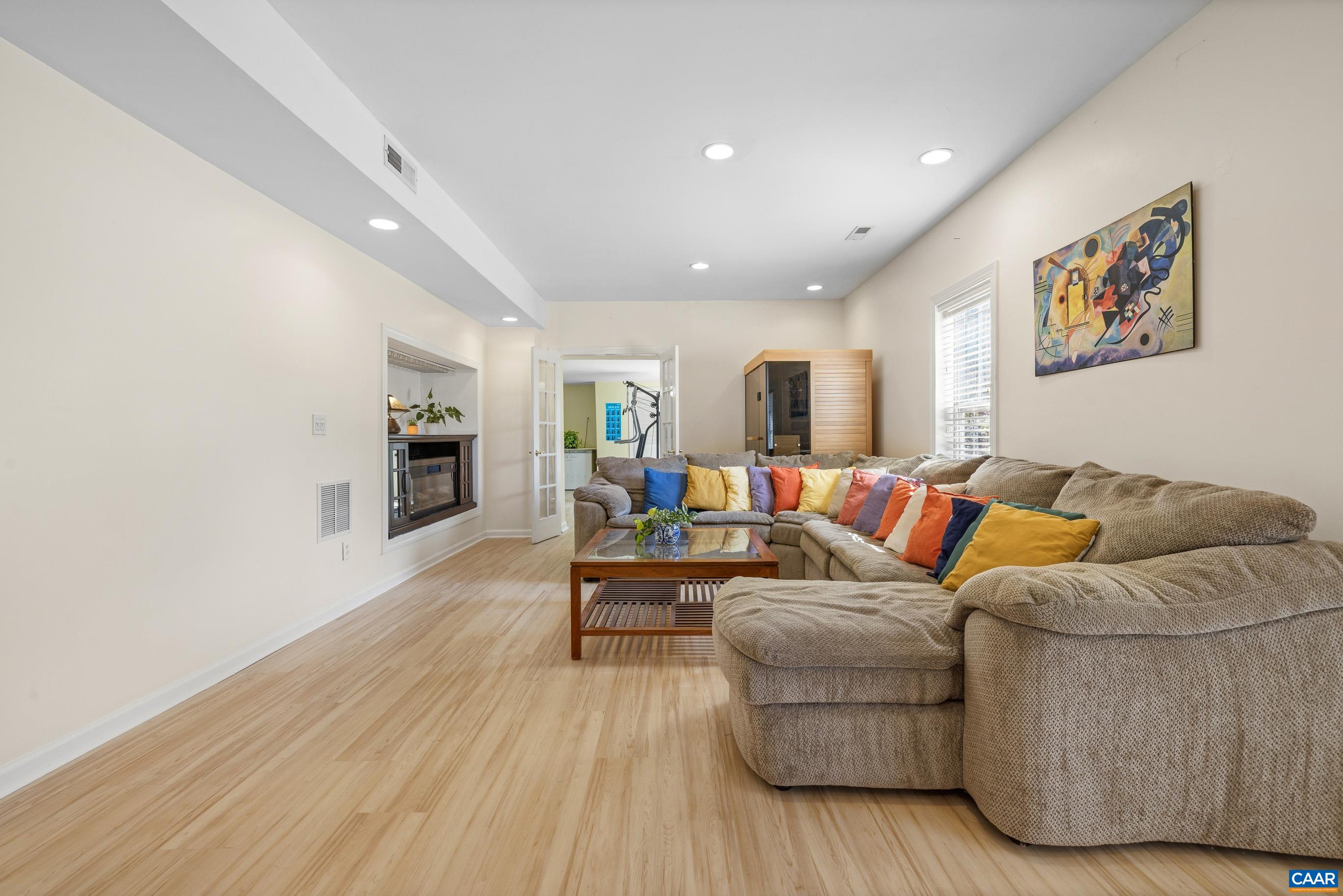 1236 Amber Ridge Road Charlottesville, VA 22901 - Photo 41 of 56 a living room with furniture and a wooden floor