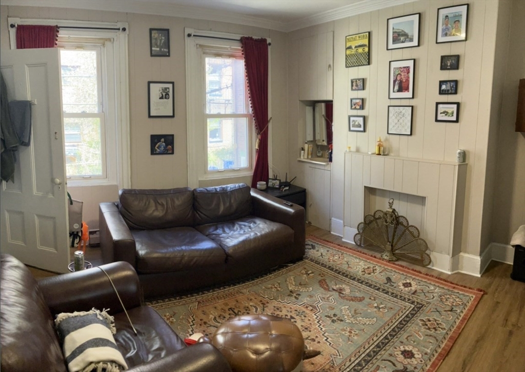 7 Johnny Court, Unit 1 Boston, MA 02111 - Photo 2 of 8 a living room with furniture and a rug