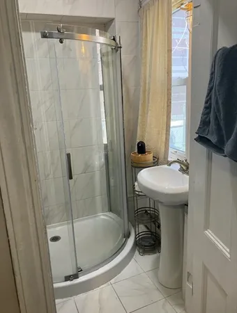 a bathroom with a sink a mirror a bathtub and shower