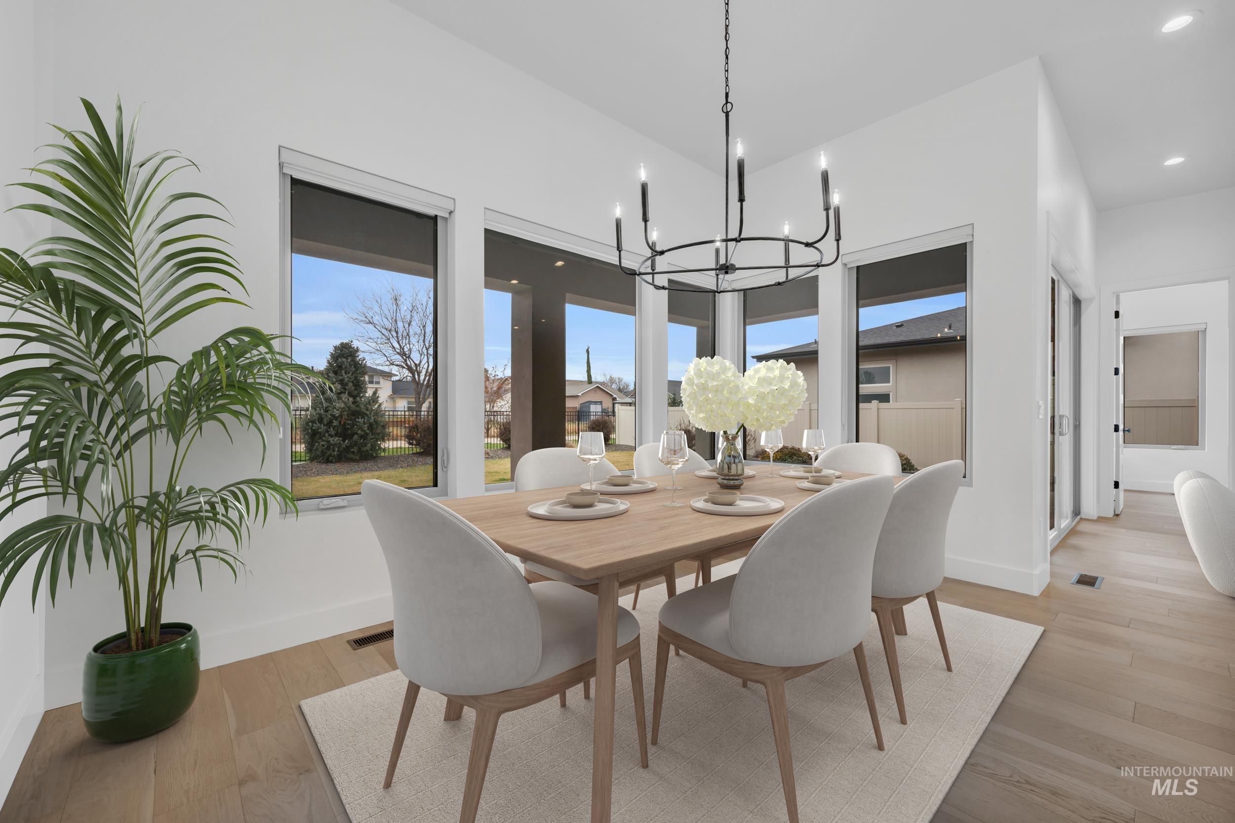 4447 East Copper Point Drive Meridian, ID 83642 - Photo 15 of 41 Dining area with light wood-style flooring, a chandelier, and recessed lighting