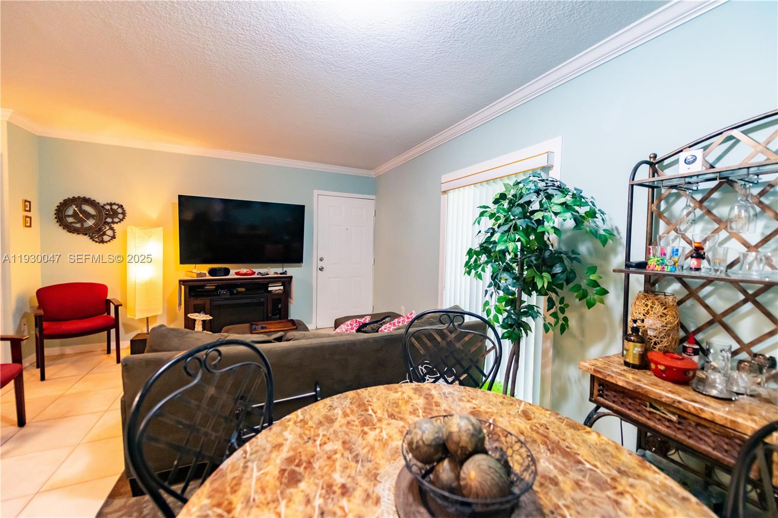 63 Northwest 17th Place, Unit 6 Miami, FL 33125 - Photo 11 of 25 a bedroom with furniture and a flat screen tv