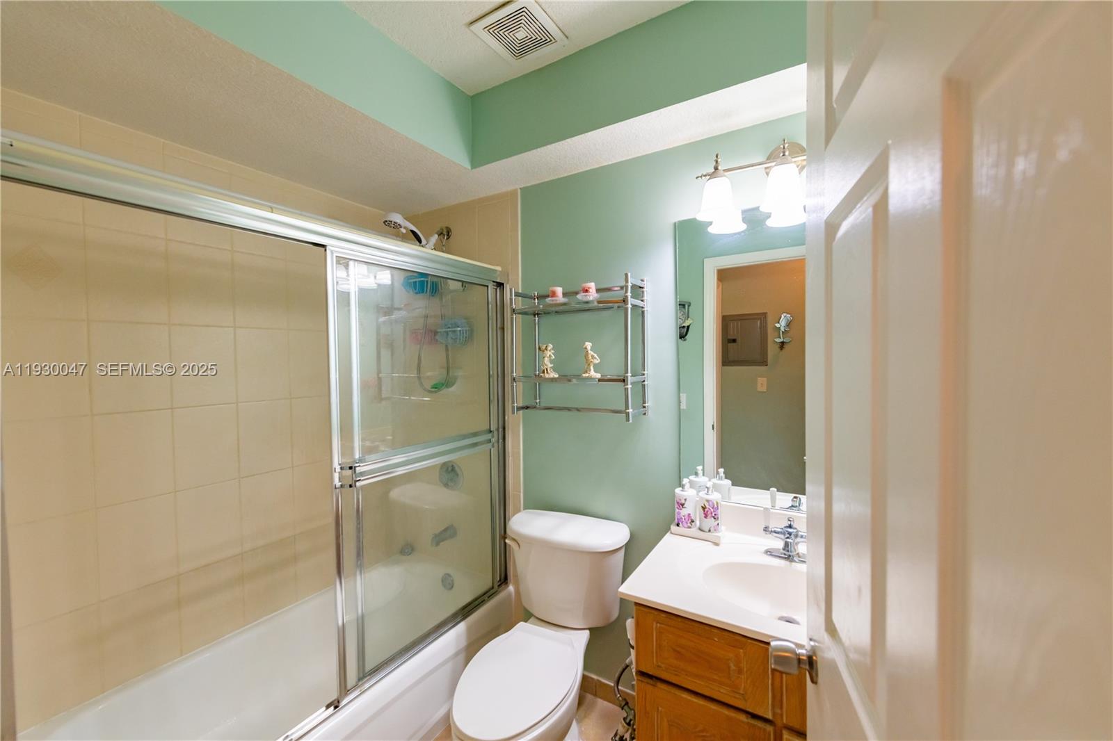 63 Northwest 17th Place, Unit 6 Miami, FL 33125 - Photo 12 of 25 a bathroom with a sink toilet and shower