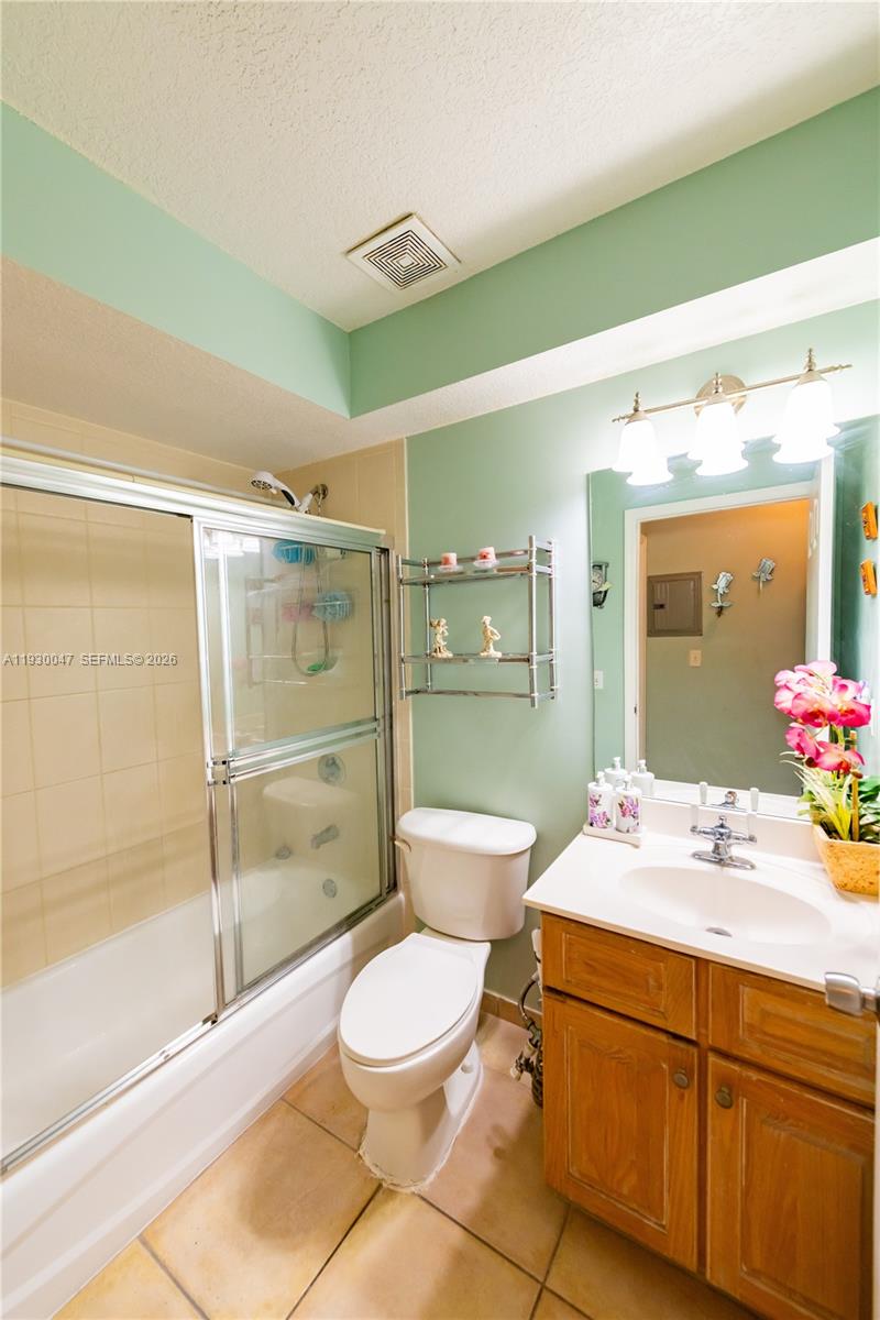 63 Northwest 17th Place, Unit 6 Miami, FL 33125 - Photo 13 of 24 a bathroom with a sink a toilet and shower