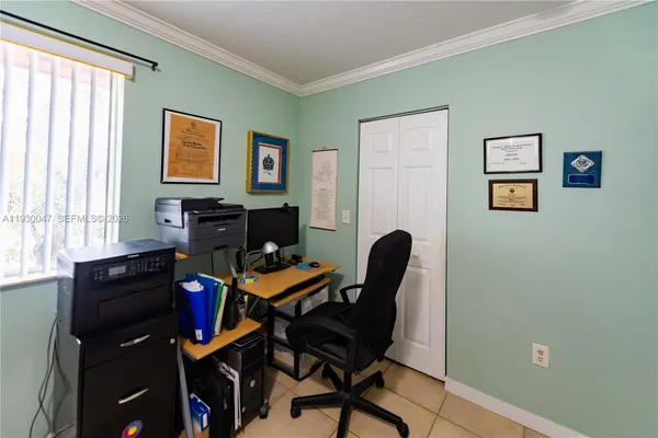 a bedroom with a bed and chair with the dresser