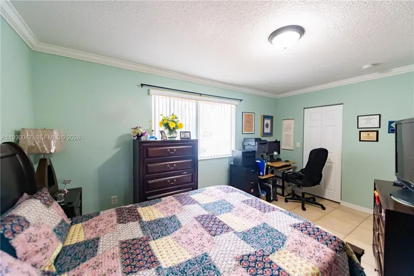 a bed room with a bed window and a mirror