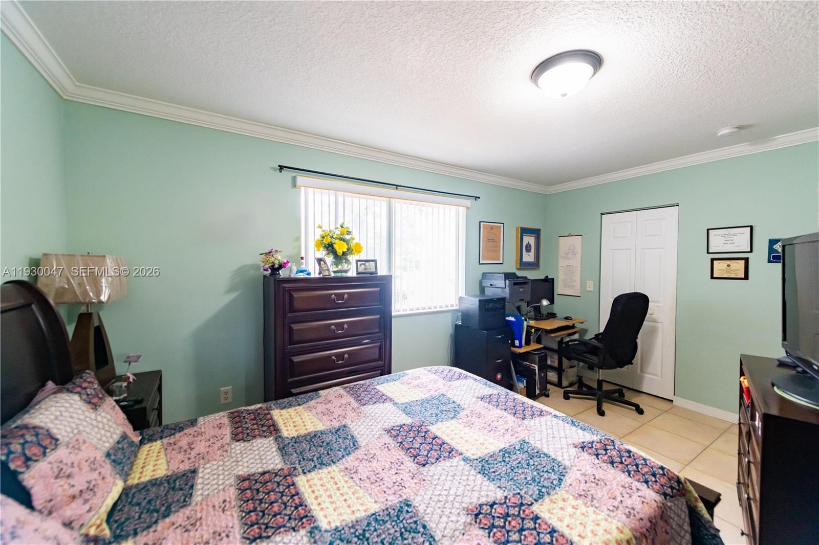 63 Northwest 17th Place, Unit 6 Miami, FL 33125 - Photo 15 of 24 a bedroom with a bed and chair with the dresser