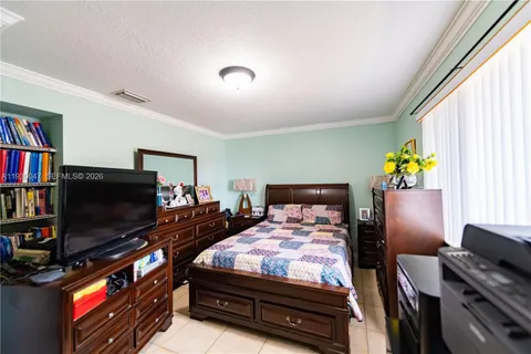 a bed room with furniture and flat screen tv