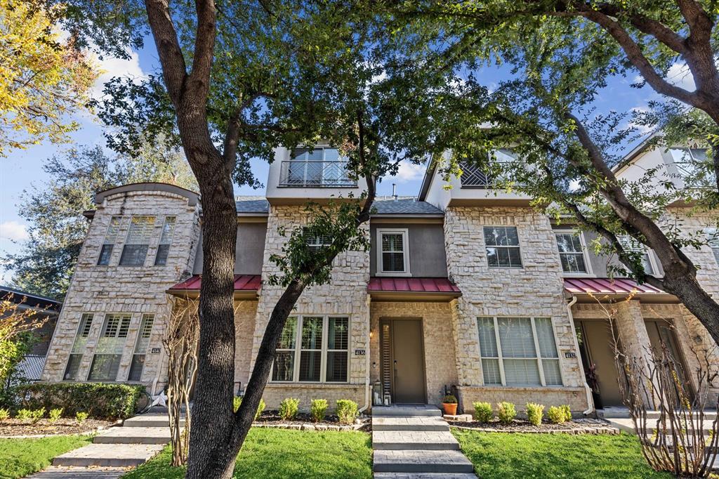 front view of a house with a tree
