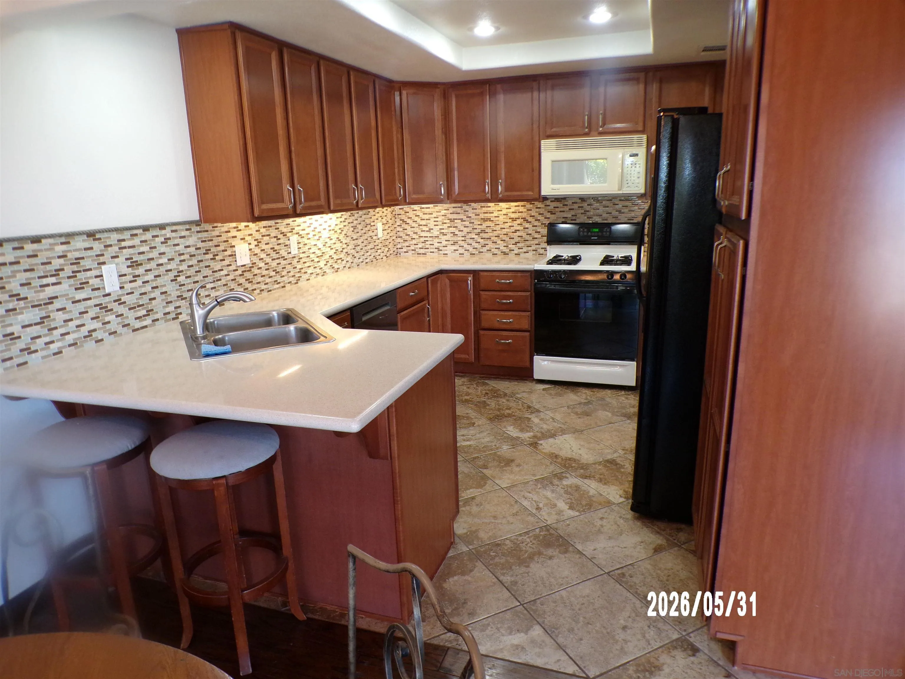 13592 Ridley Road San Diego, CA 92129 - Photo 7 of 25 a kitchen with a sink cabinets and wooden floor