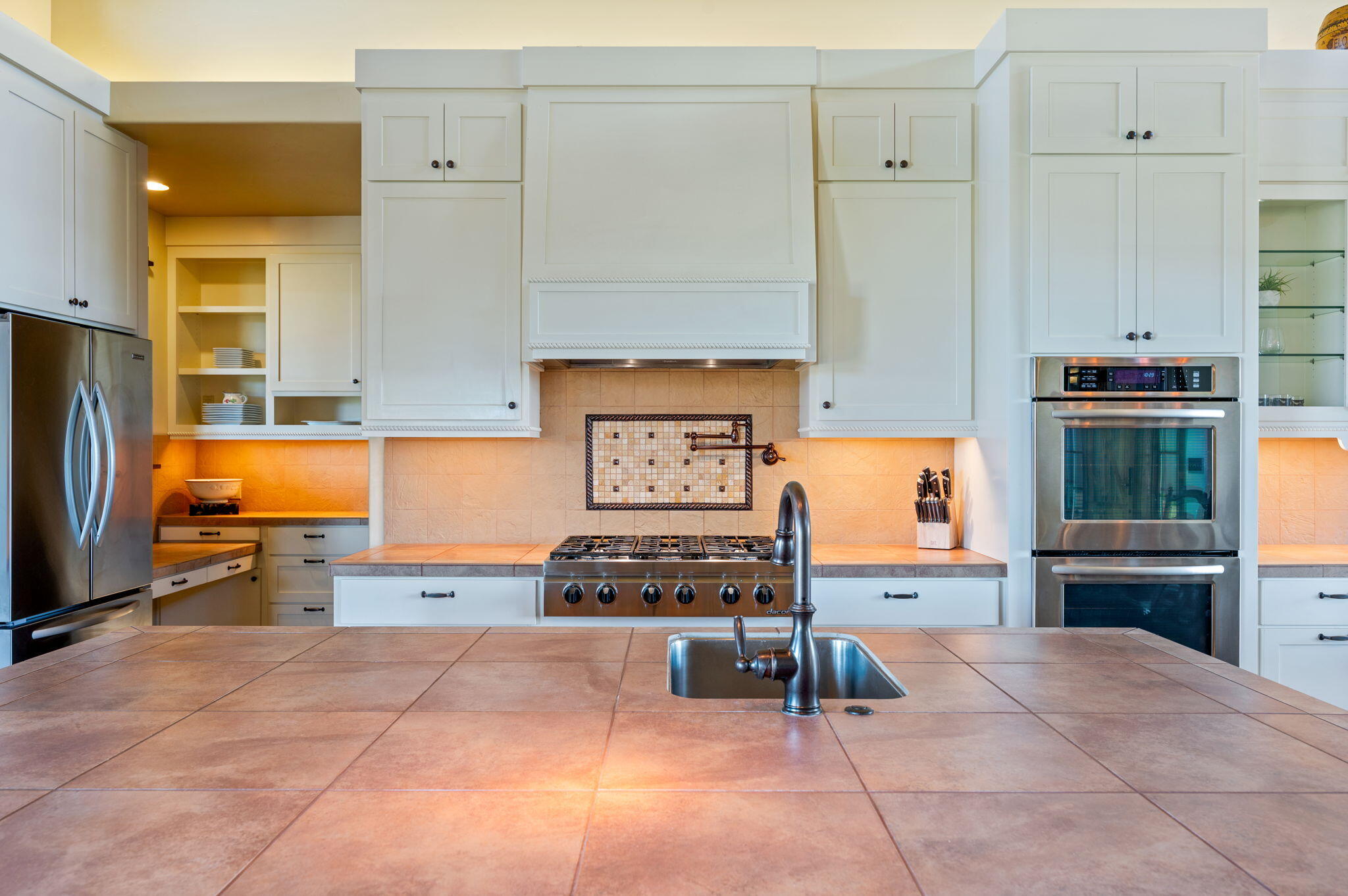 71285 Holmes Road Sisters, OR 97759 - Photo 18 of 123 a kitchen with stainless steel appliances kitchen island granite countertop a refrigerator and a stove top oven