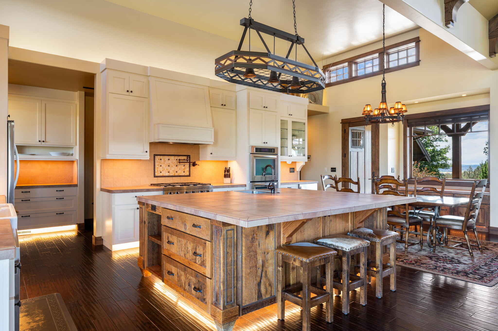 71285 Holmes Road Sisters, OR 97759 - Photo 24 of 123 a kitchen with stainless steel appliances granite countertop a table chairs in it and wooden floors