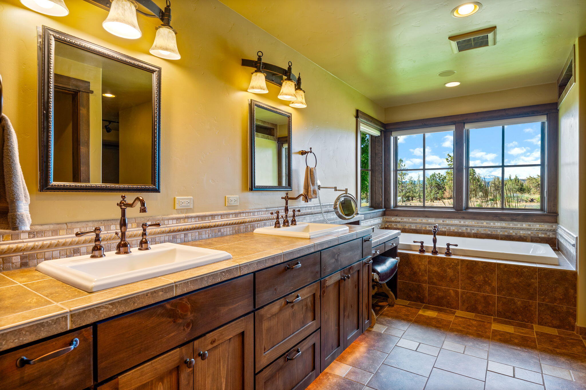 71285 Holmes Road Sisters, OR 97759 - Photo 30 of 123 a spacious bathroom with a granite countertop sink and a large mirror