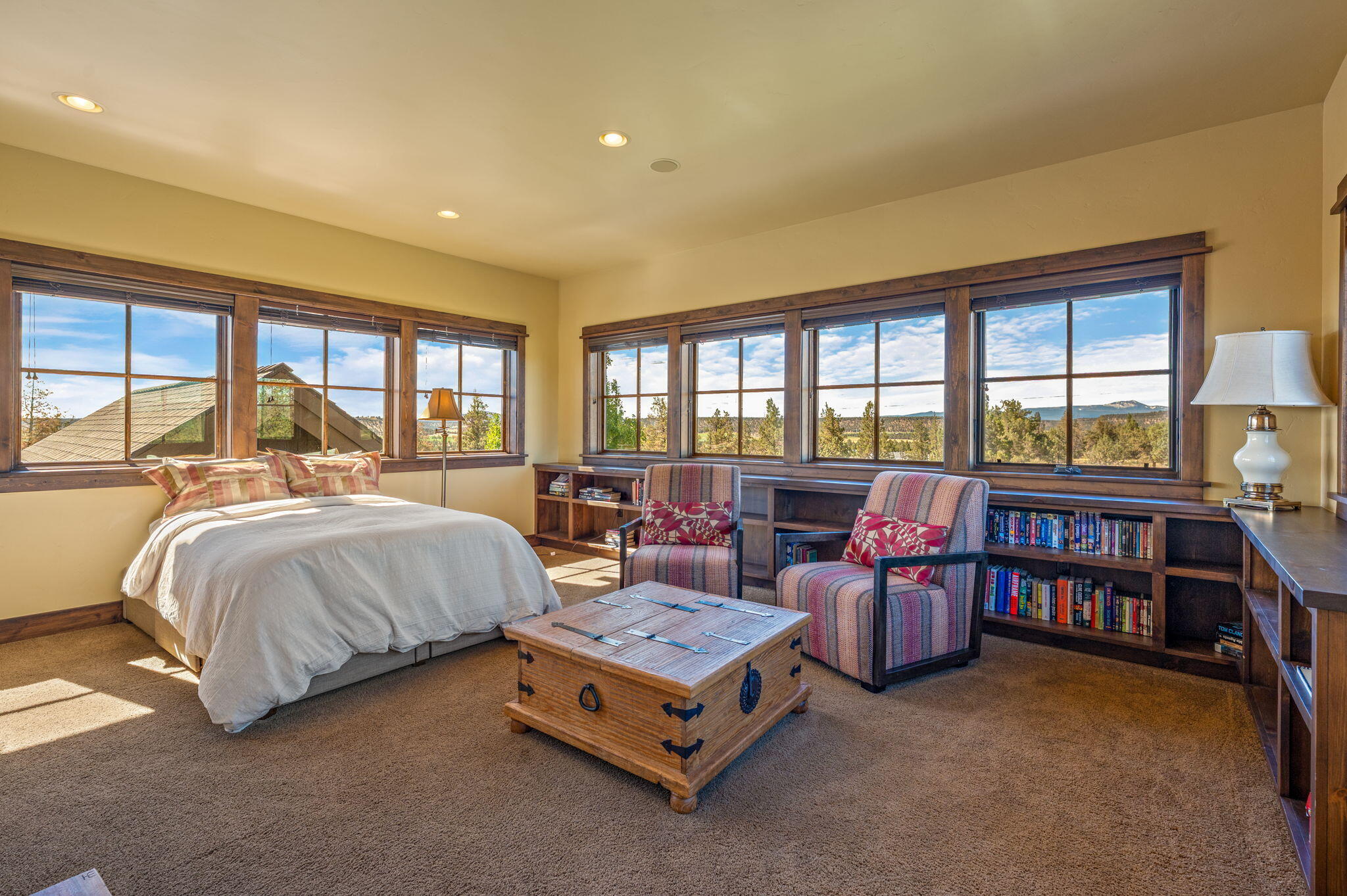 71285 Holmes Road Sisters, OR 97759 - Photo 38 of 123 a spacious bedroom with a bed couch and a large window