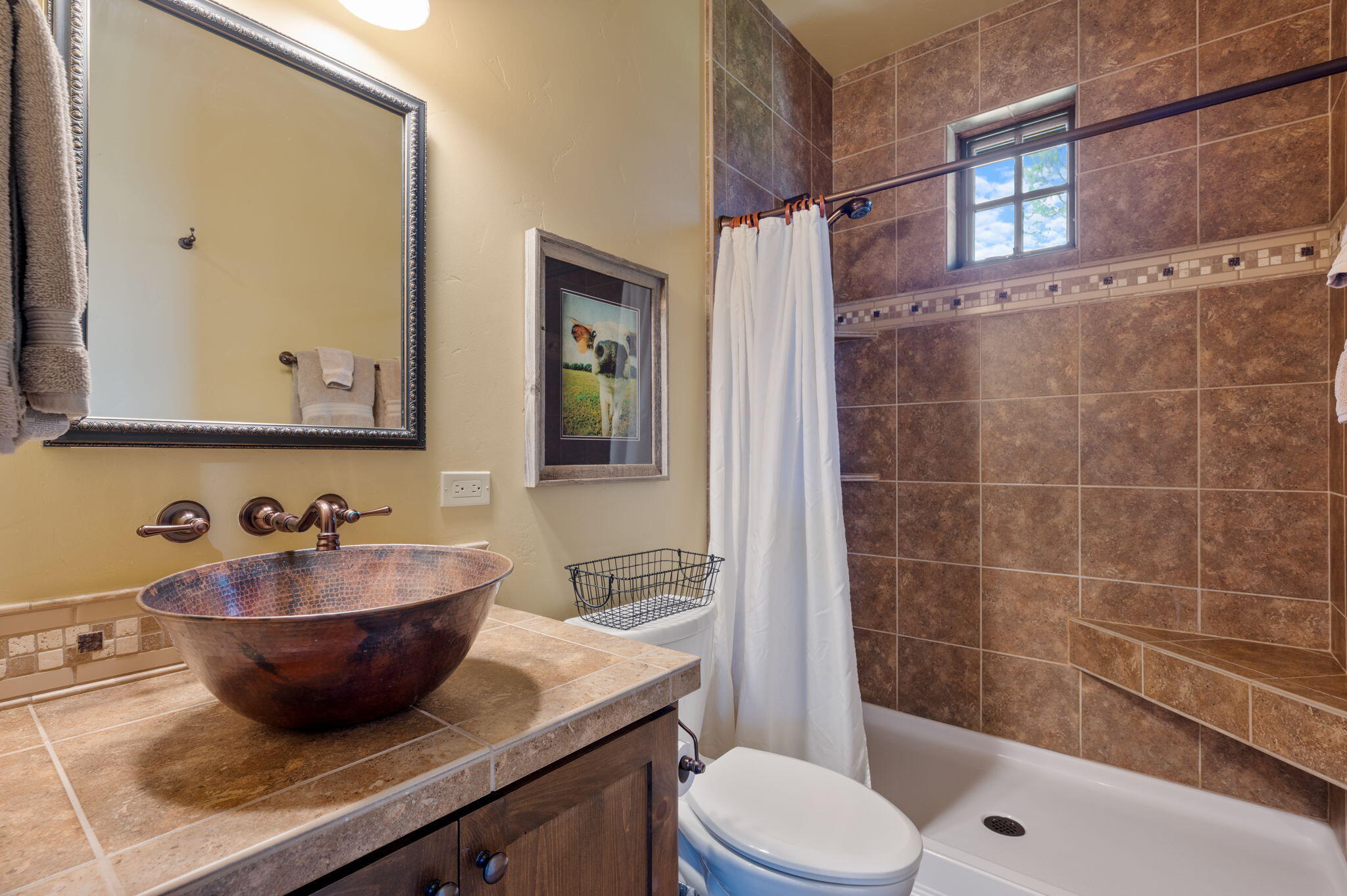 71285 Holmes Road Sisters, OR 97759 - Photo 52 of 123 a bathroom with a granite countertop sink a toilet a mirror and shower