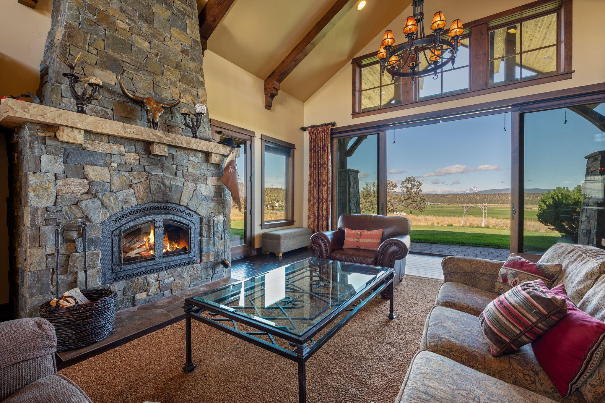 71285 Holmes Road Sisters, OR 97759 - Photo 6 of 123 a living room with furniture a fireplace and floor to ceiling windows