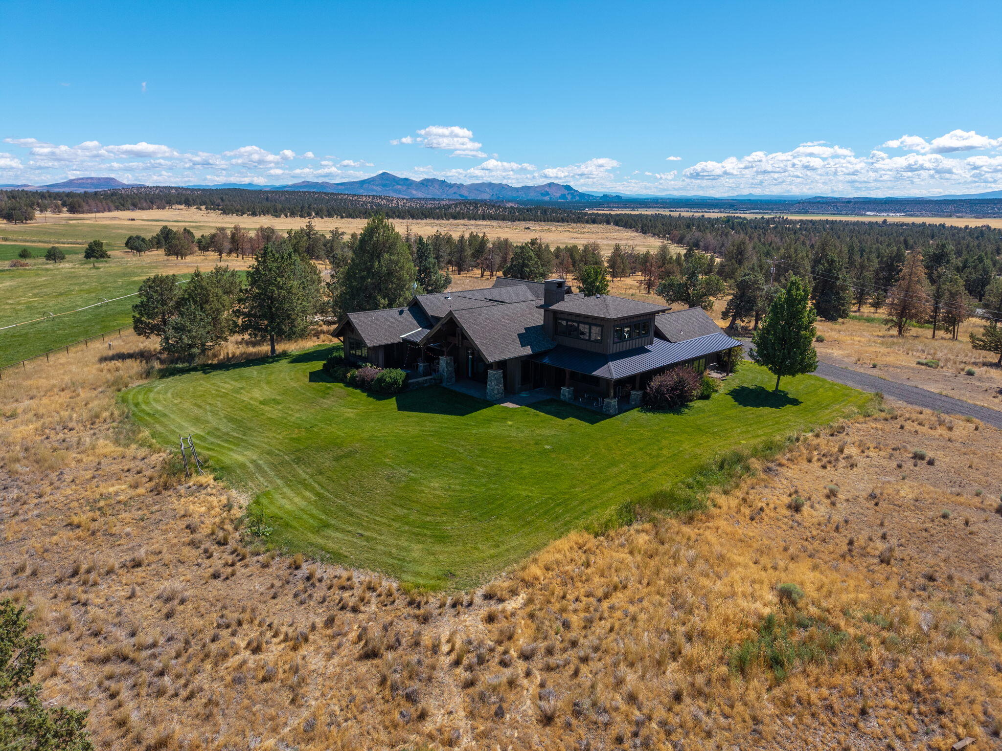 71285 Holmes Road Sisters, OR 97759 - Photo 68 of 123 a view of a lake with lawn chairs and large trees